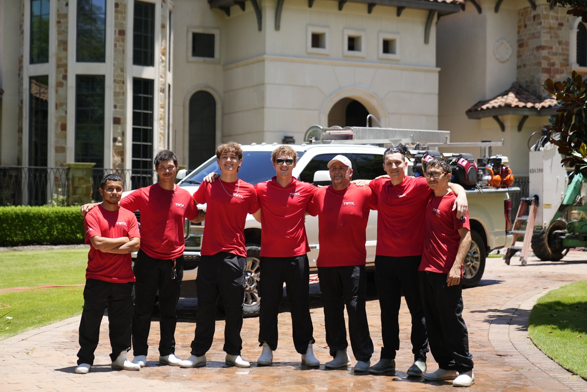 The Amazing Power Wash team powered by TWTX in front of their fully-equipped service truck